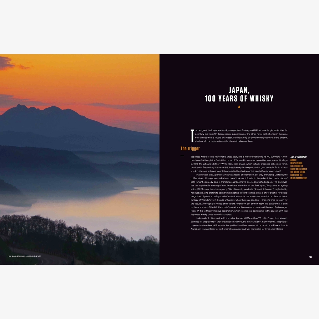 An interior spread with a focus on Japanese whisky, with a photograph of a mountain landscape at dawn.